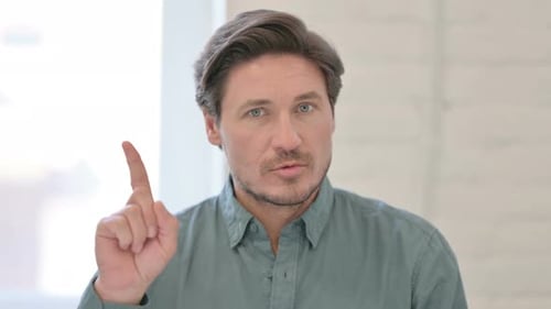 No Sign by Middle Aged Man by Finger Gesture