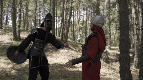 Medieval Figures Confrontation Ending in Sword Fight in Forest