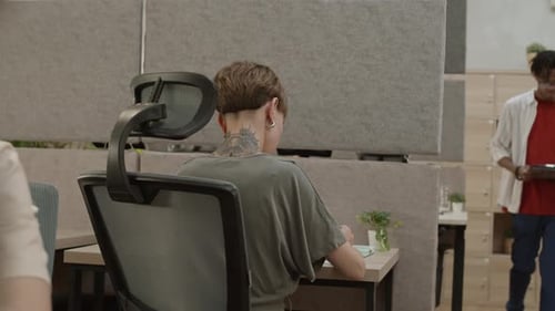 Businesswoman Writing Notes and Smiling in Office