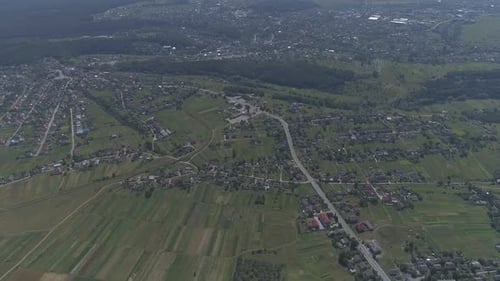 Aerial view of a village surrounded by crops