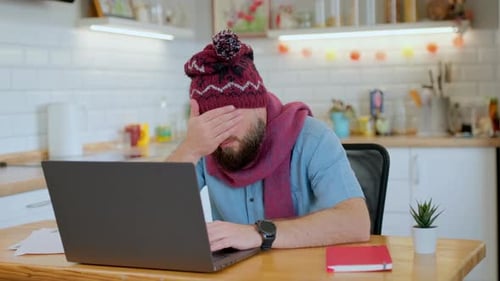 Man Working On Laptop With Cold and Headache