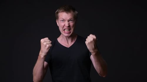 Young Handsome Man Against Black Background