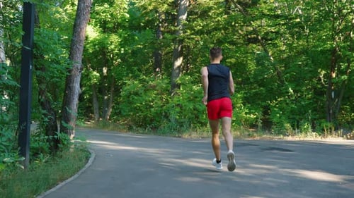 Slow motion jogger running in park