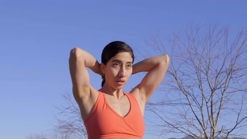 Young fit woman fixing hair before outdoor run