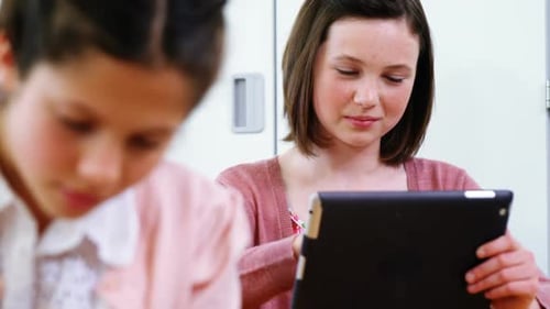 School girl using digital tablet in classroom