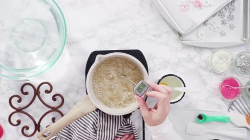 Flat lay. Step by step. Caramelizing sugar in a small cooking pot over the small electric stove