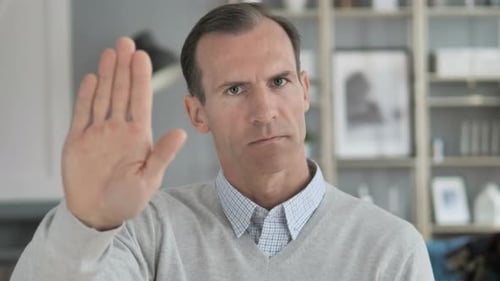 Man Puts Hand Up In Stop Gesture