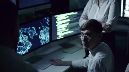 Group of Programmers Having Office Meeting at Night