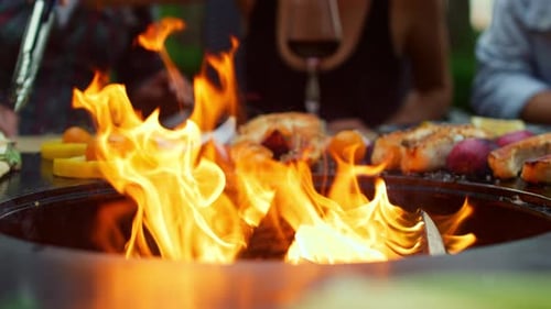 Closeup Fire Flames Burning in Bbq Grill on Backyard