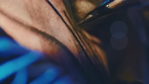 Macro Shot of Pattern Filling with Electric Tattoo Machine Magnum Bar Needles