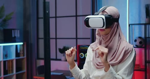 Woman Using Virtual Reality Headset Indoors at Night
