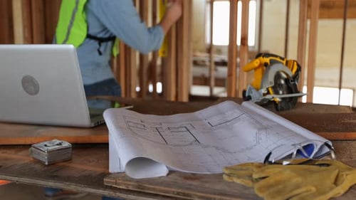 House plans and tools on construction site