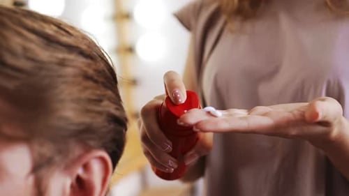 Hair Stylist Preparing Hair Product for Client