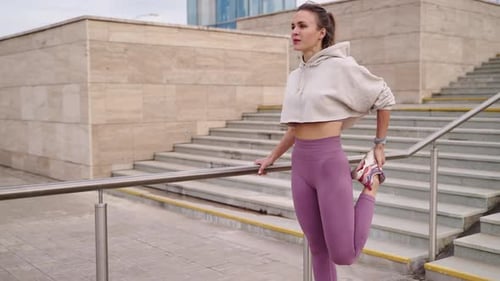 Woman Stretching Leg Muscles by Urban Steps