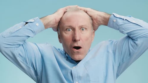 Man Reacts with Shock and Surprise