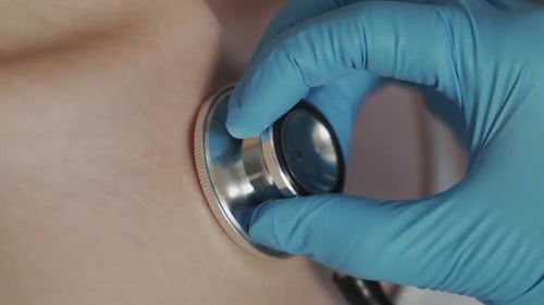 Medical Professional Using Stethoscope for Examination Close Up