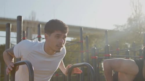 Male Buddies Doing Press Ups on Bar Outdoor