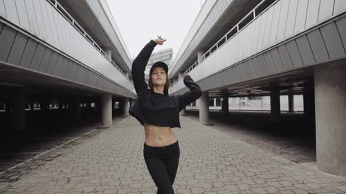 Woman Dancing Gracefully in Urban Setting