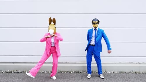 Masked People in Suits Perform Playful Dance