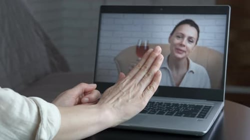 Woman Waving During a Laptop Video Conference