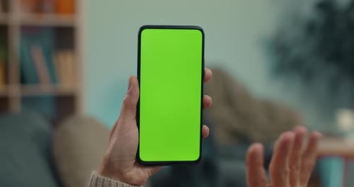 Woman Using Smartphone with Green Screen for Video Call