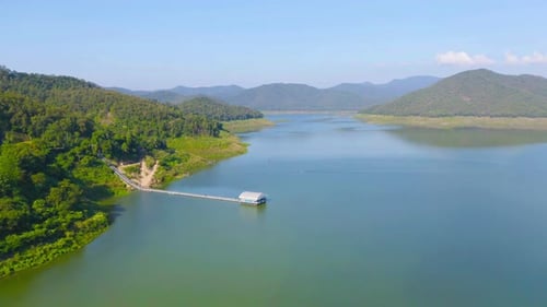 Aerial top view of forest trees with lake or river in travel and environment concept