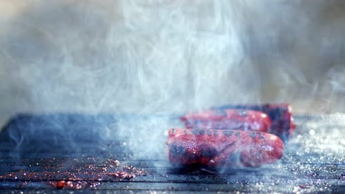 Sausage In Smoke On Barbecue Fire