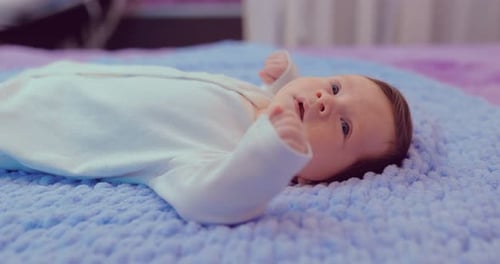 Cute Infant Lying on a Blue Blanket