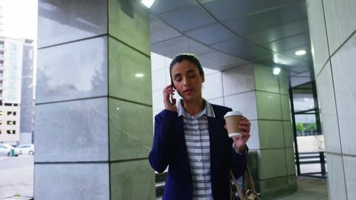 Woman Walking and Talking on Mobile Phone