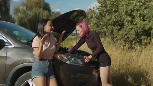 Women Troubleshoot Engine in Rural Roadside Location