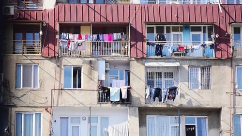 Residential Building with Laundry on Balconies in City