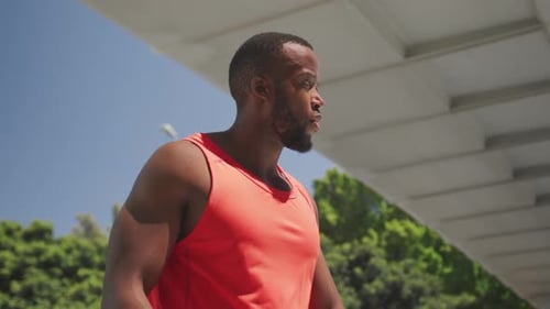 Man Uses Smartwatch Under Urban Overpass