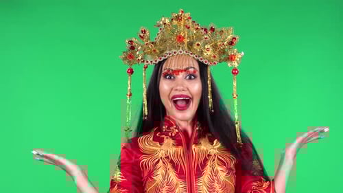 Woman Smiles in Traditional Dress in Front of Green Screen