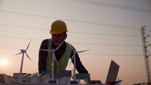 Asian engineer, foreman or leader discussion about home solar cell farm and wind turbine model