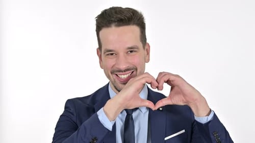 Businessman Making Heart Shape Hand Gesture Smiling