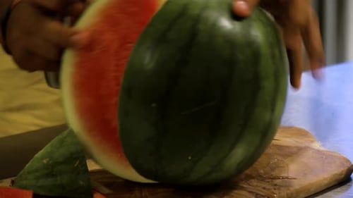 Male Hand Cuts Watermelon