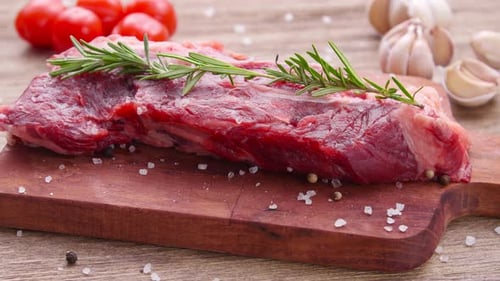 Raw Steak Garnish on Cutting Board Close Up