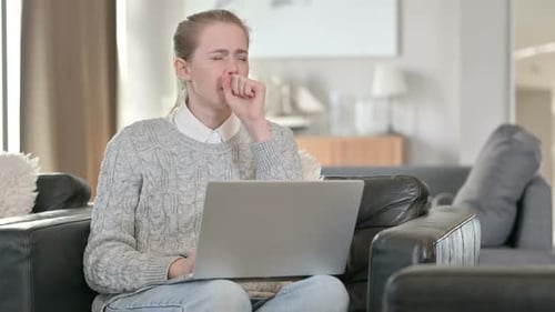 Woman Coughing While Using Laptop at Home