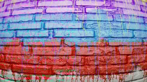 Vibrant Fluid Paint Dripping on a Textured Brick Wall