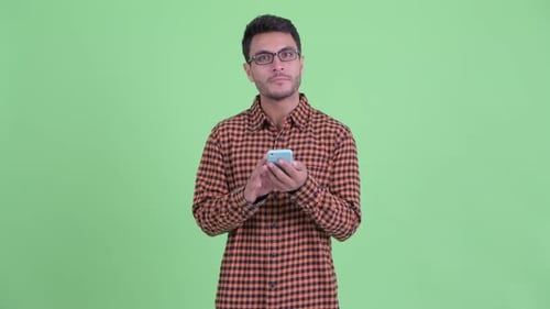Man Using Phone, Smiling, Green Background