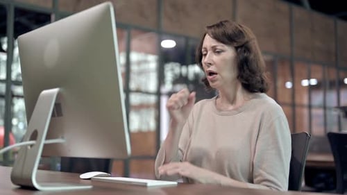 Woman Coughs While Working at Computer in Office