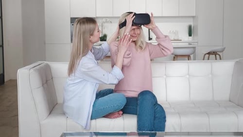 Woman Helps Senior Use Virtual Reality Headset