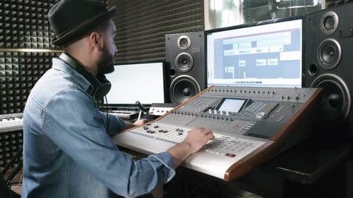 Audio Engineer Making Music in Recording Studio