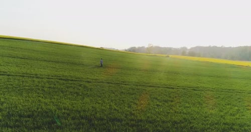Agriculture, Male Farmer Walking on Track Over Agricultural Field