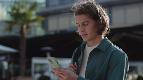 Young Adult Using Mobile Phone Outside