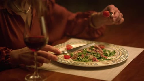 Senior Woman Enjoys Salad and Red Wine Dinner