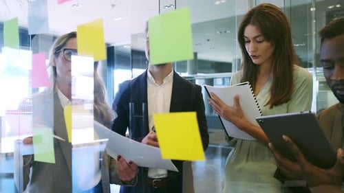 Coworkers Brainstorming Ideas Together in Modern Office