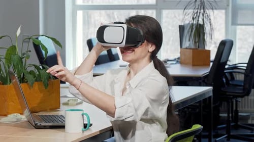 Woman Using VR Headset in Modern Office