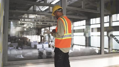 Young Engineer Man Analyzing at Construction Site