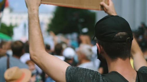 Crowd Holding Signs at Outdoor Demonstration